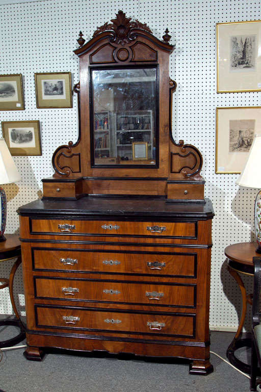 This handsome dresser with attached mirror was made in Sweden around 125 years ago. We aren't sure of the wood, but we we believe it to be chestnut. It has a marble top, black withwhtie graining. The first height measurment is for the chest alone,