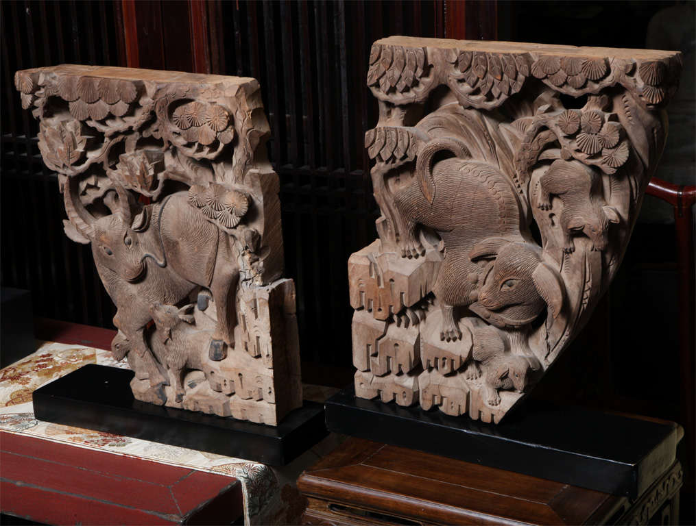This splendid pair of hand-carved temple architectural beam supports was made in China in the mid-19th century. The detailed carving features a pleasant scene with two animals possibly oxen and their young, climbing stylized rocks placed underneath