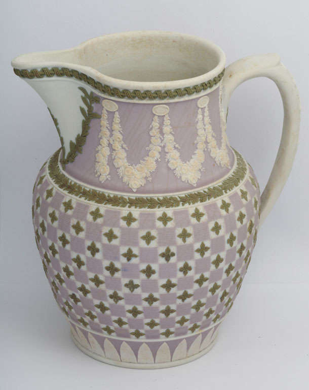 A rare and fine Wedgwood three color jasper pitcher, green and lilac on white, decorated in a diced pattern with floral swags, upper case mark