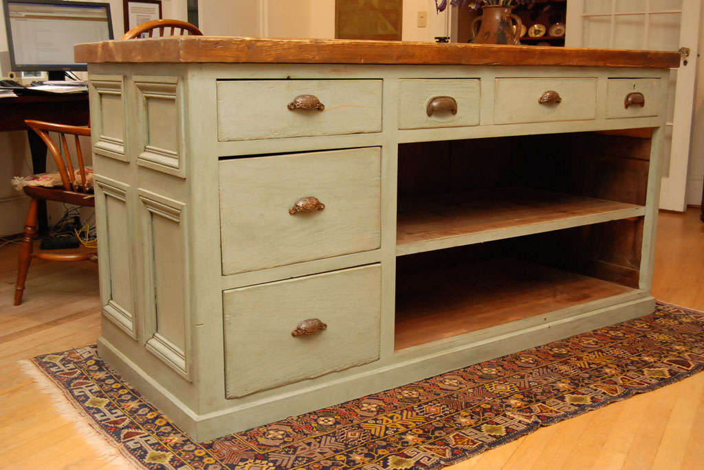 Straight from on old general store in England, refreshed with a coat of light green paint, this one of a kind piece is now ready to become a center island. its thick top, almost 2.5