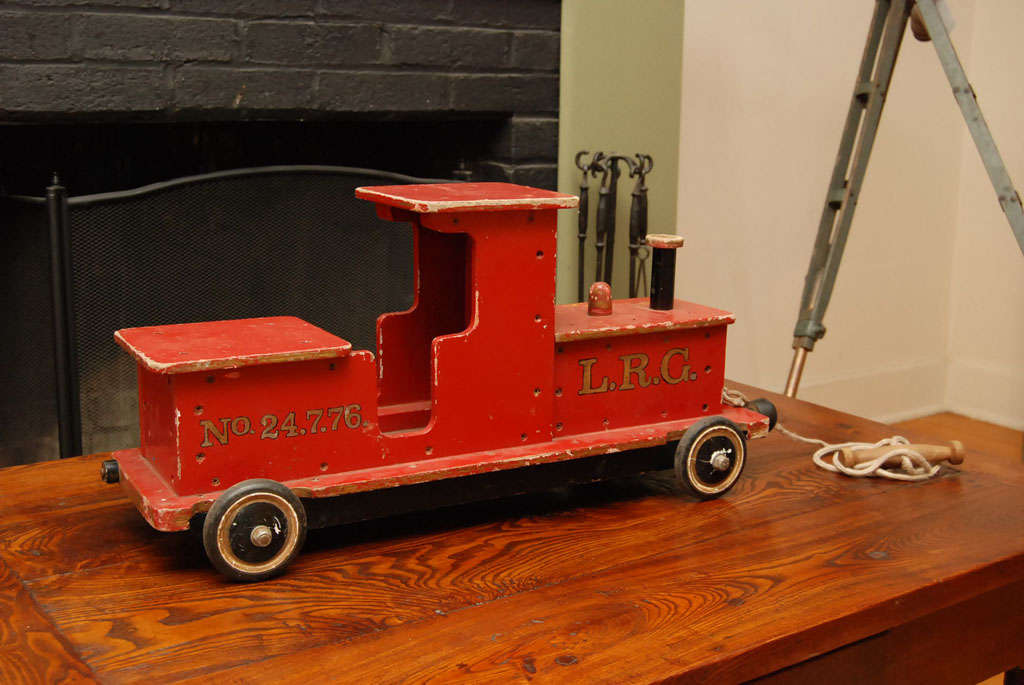 This original painted antique toy train is part of the collection of Painted Porch. We collect children's toys, games, etc and this is a stunner. complete with pull rope, this toy came from a home in the south of England and dates about 1920. Ask us