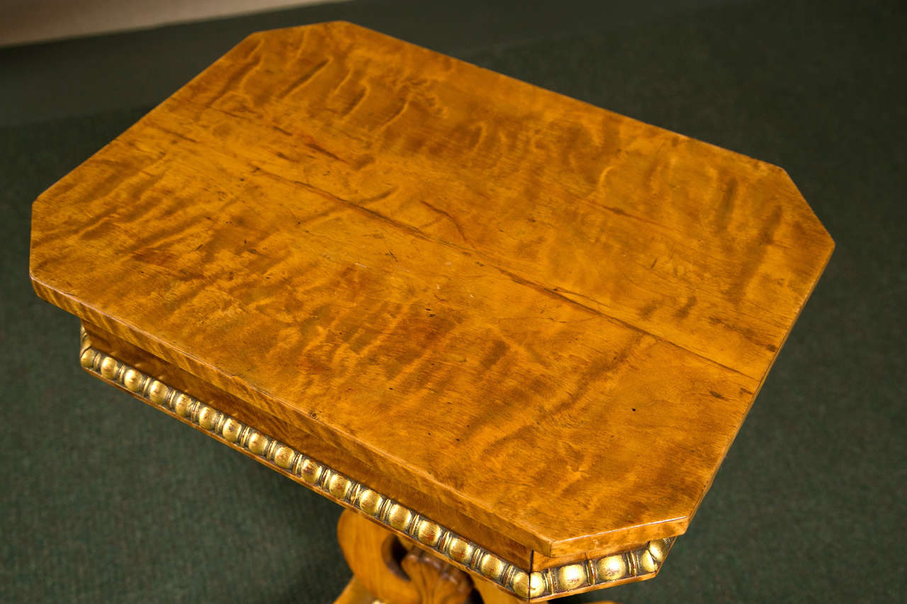 A Continental lyre form side table in burled Amboyna wood.