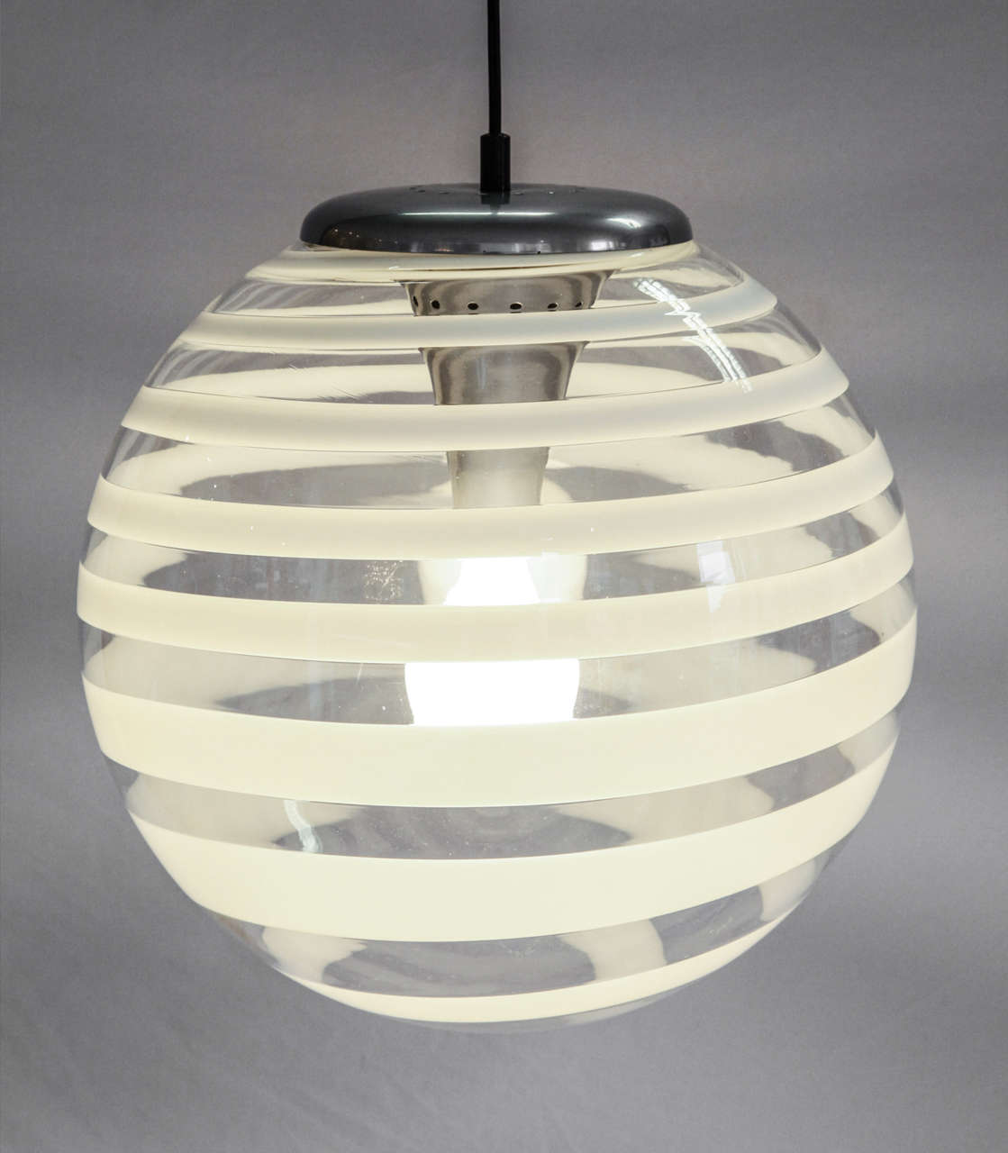 An impressive glass pendant with a white stripe executed by a Murano glass workshop.