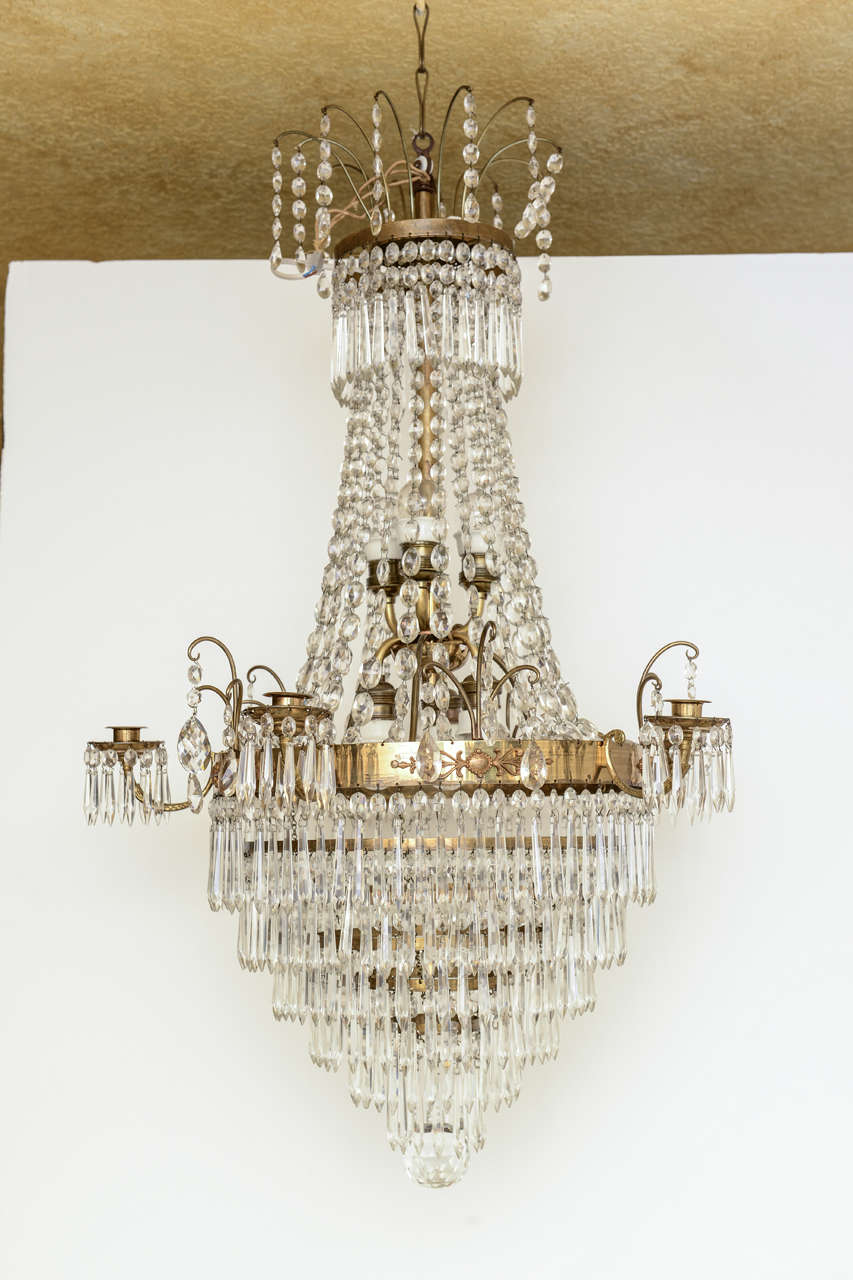 Exquisite crystal chandelier, circa 1850-1860. Swedish
Frame is brass with gilt bronze detailing and diamond shaped crystals. 
Chandelier has five arms for candles; has been electrified to accommodate six 
Edison base small scale bulbs in the