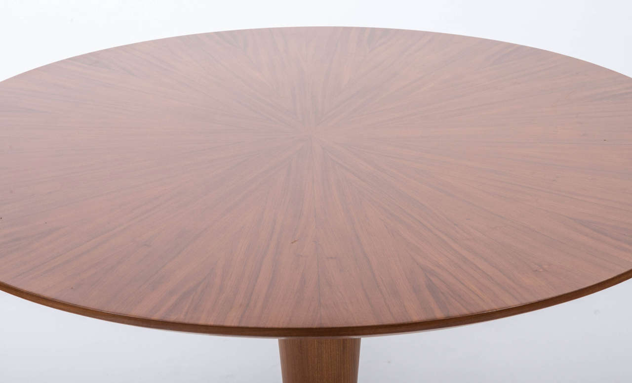 A mahogany circular centre table attributed to Paolo Buffa.
The top with radial veneers upon a conical pedestal raised on three outswept brass feet.
Italian,
circa 1950.
Measures: 30.5” H x 46.5” diameter.