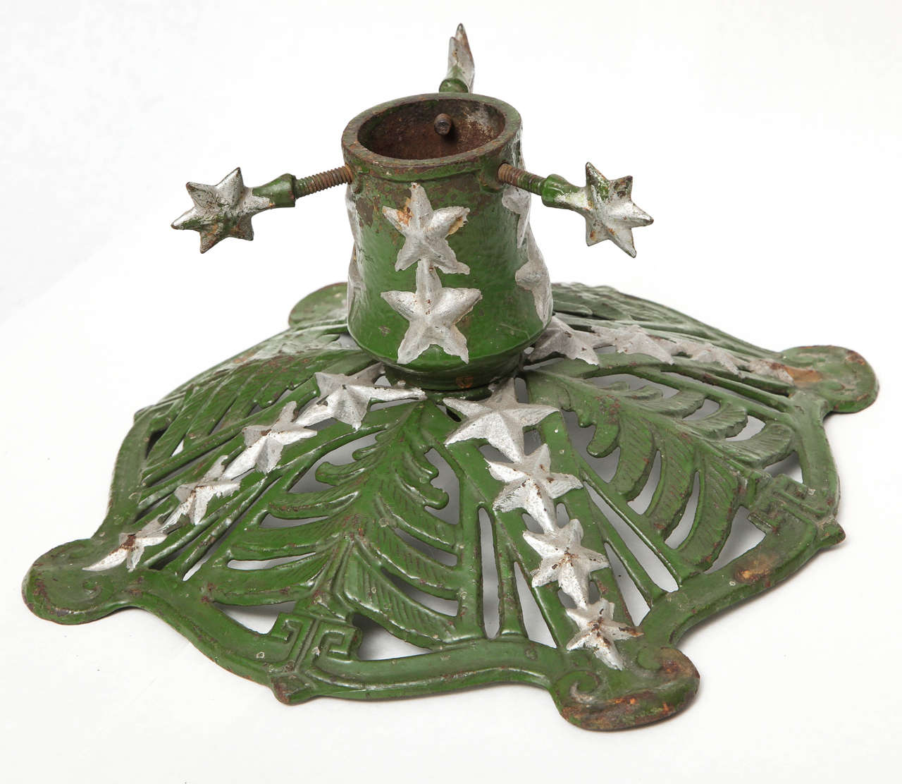 Wonderful 'round' Christmas tree stand, Germany, circa 1920s.
This stand features Christmas trees and star decor, as well as star-shaped screws, original paint in green and silver. It is marked underneath ‘KT.’
Measurements: 11” diameter, 5 1/2”