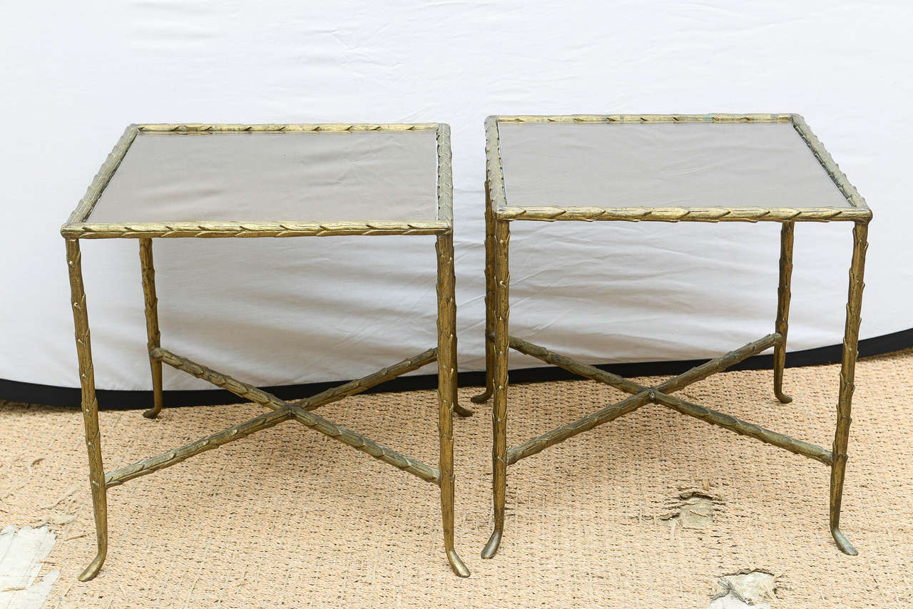 These classical and versatile Bagues Maison Jansen style vintage mid century modern bronze side/ end tables are influenced by a gentle regality.  The bronzed mirror on top just floats into the table. The mirrored glass tops were replaced.

