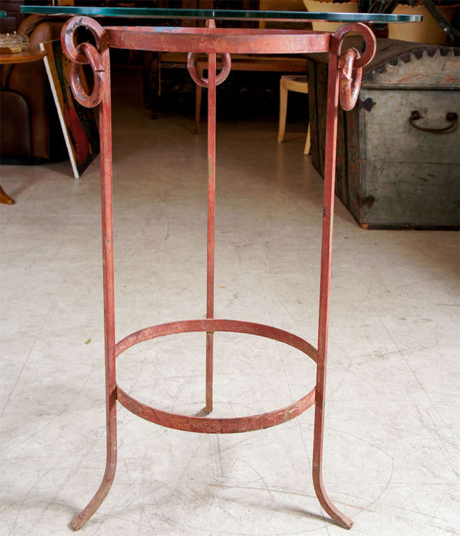 Pair of wrought iron stands with glass tops in neoclassical form.