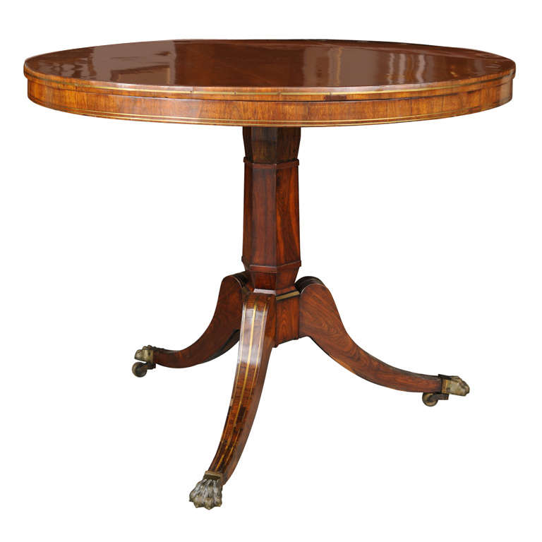 The top with star inlay and further band inlay above a central pedestal with tripartite base and brass animal paw feet.