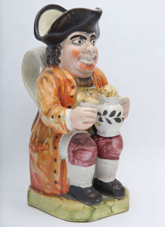 A rare and fine English creamware postillion toby jug decorated in enamel glazes