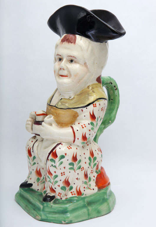 A fine English creamware Martha Gunn toby jug decorated in enamel glazes