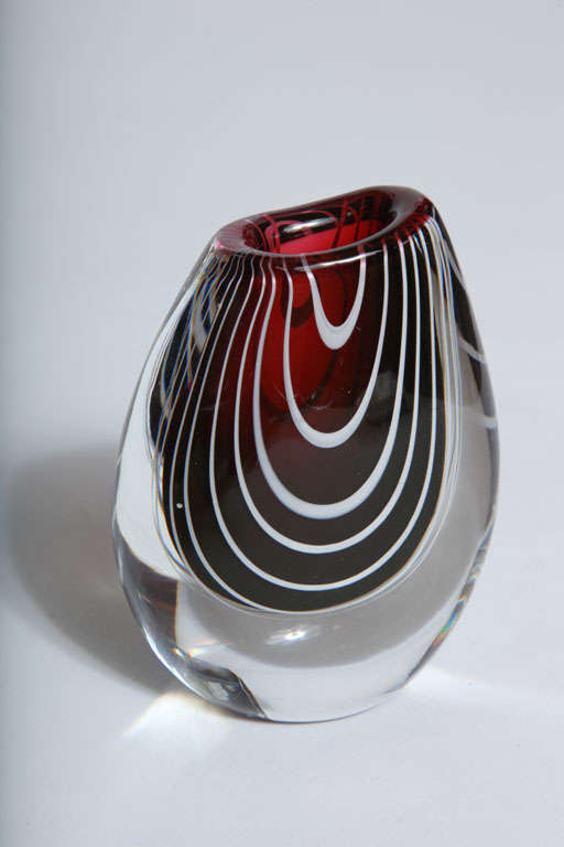 A lovely hand blown vase by Vicke Lindstrand for Kosta. Red and opaque white encased in clear glass.