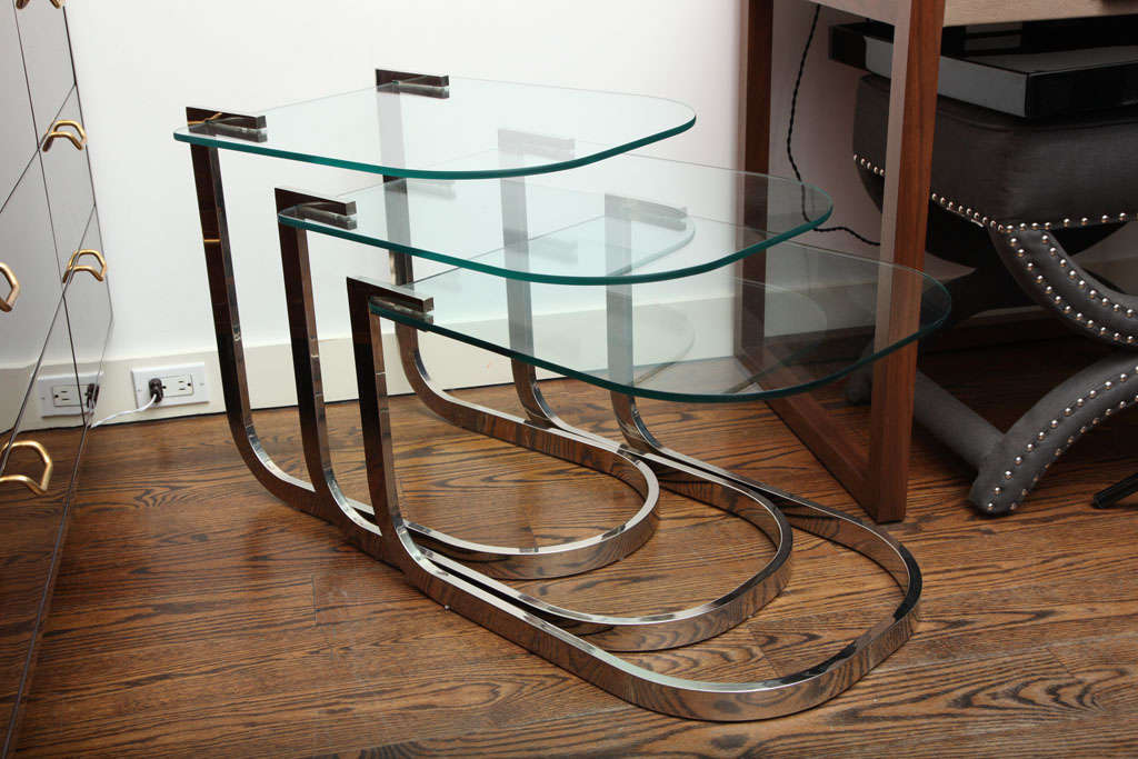 A sinuous set of chrome and glass nesting tables by the Design Institute of America.