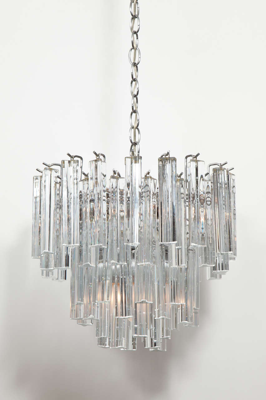 Camer chandelier made with clear Murano glass bar prisms hanging from a steel frame.