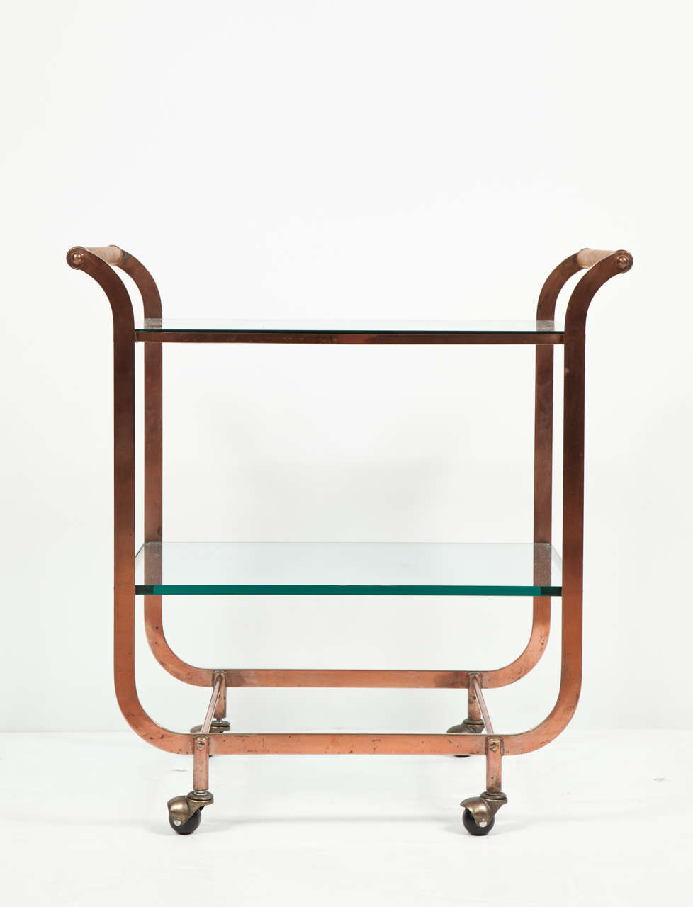 Exceptional Art Deco copper framed bar cart with two glass shelves, rattan wrapped handles and brass casters.
Saturday Sale item, reduced from 3600. No further discount.