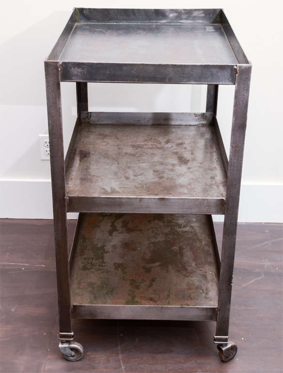 Industrial Cart with beautiful aged patina on steel finish. Cart is on casters.