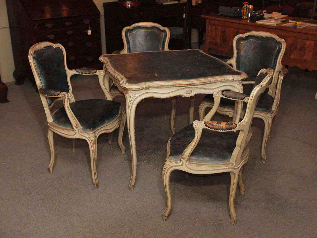 Antique French Louis XVI style painted blue leather games table with four armchairs.