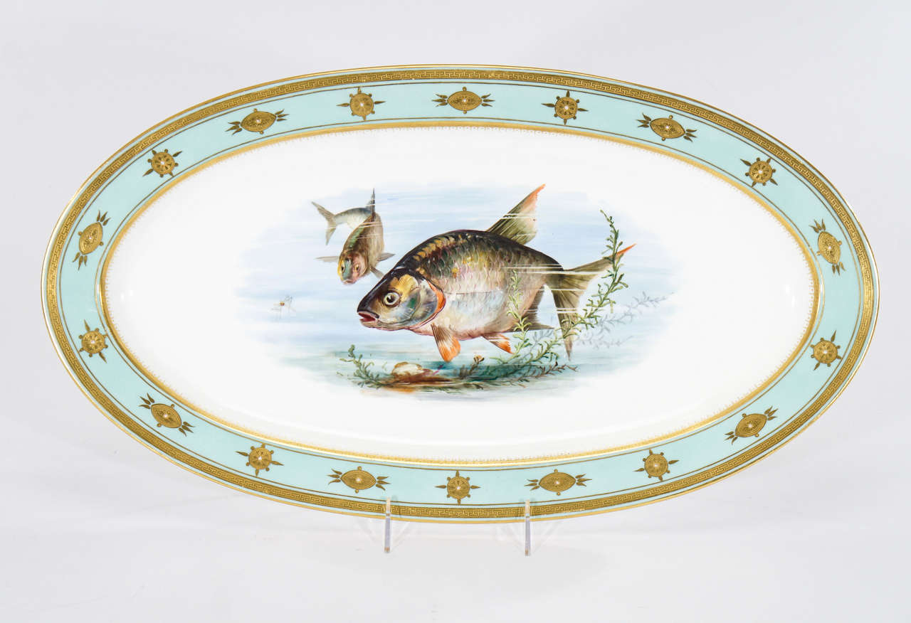 This fish platter is a true work of art! Classic Aesthetic Movement whimsical decoration with fish in motion and in conversation with the viewer, it has a three-dimensional feel. Realistically hand painted in a naturalistic polychrome enamel