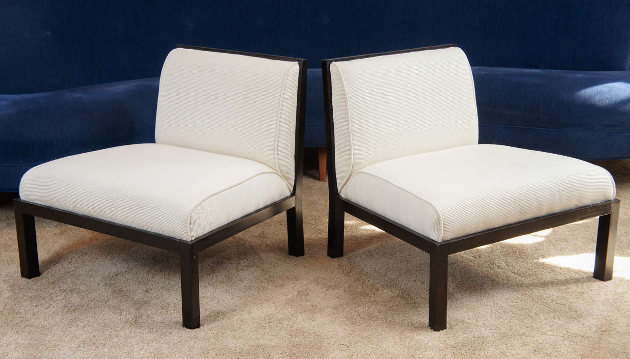 Striking pair of lattice back slipper chairs in rich ebonized wood. Newly reupholstered in a creamy off white fabric. Clean, elegant and exceptionally comfortable.