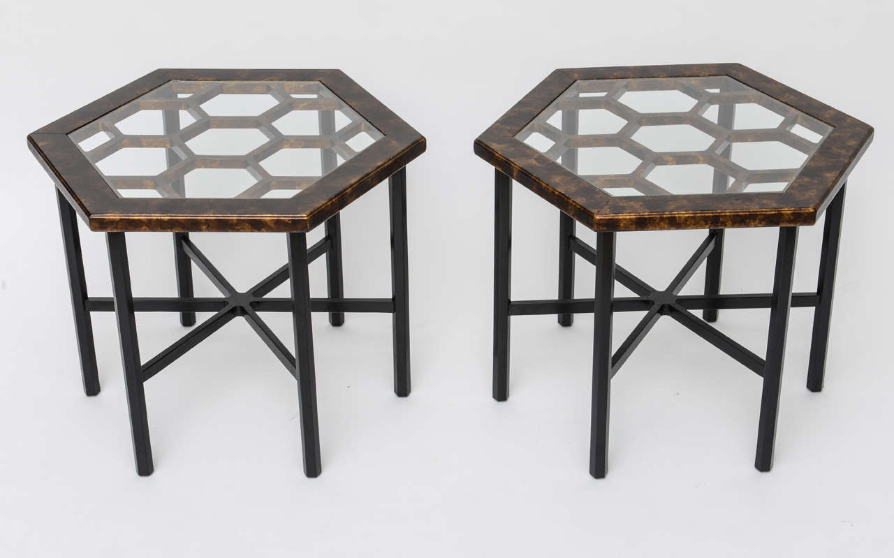 Urbane, sleek and posh darling. Occasional tables or side tables, this pair from John Widdicomb have a great hexagonal form with a honeycomb center under inset glass. Rising on six hexagonal black painted legs with star stretcher to the top with a