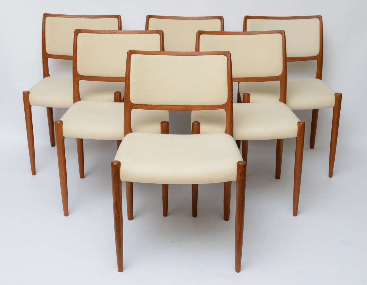 SOLD  These SIX exquisitely sculpted dining chairs by JL Moller, were designed by Niels Otto Moller in 1968.  Beautiful and excellent condition teak lathe turned and hand sculpted, they are in their original white Kvadrat fabric showing some light