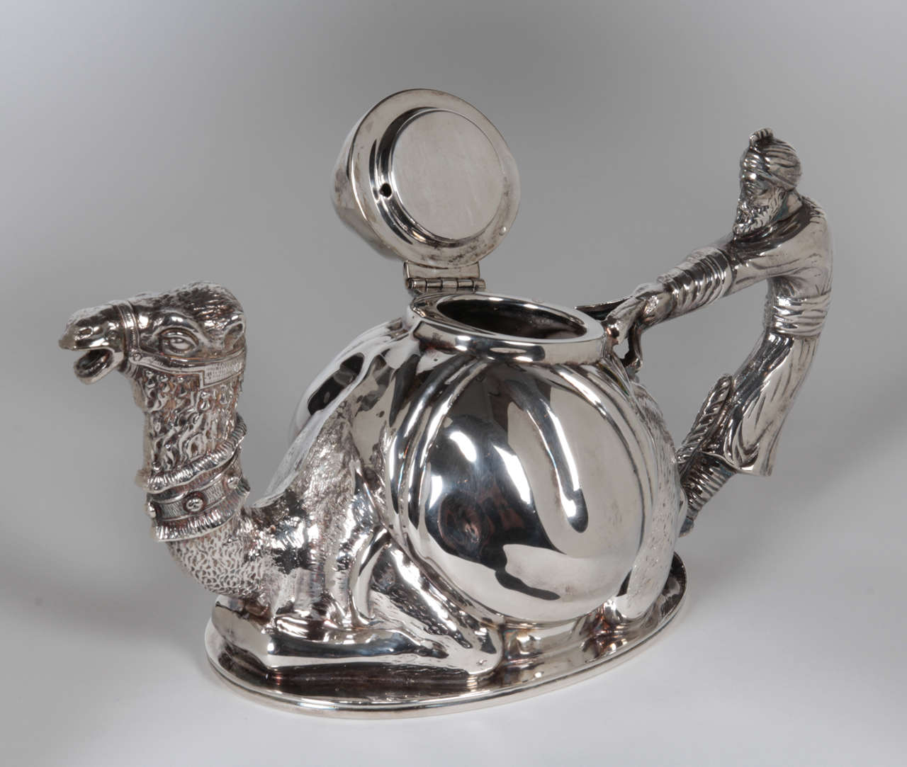 Mariage Freres, Paris

Karawan Teapot c. 1990's

Silverplated metal in the form of a seated camel and an Arabian Prince

Marks: Mariage Freres, Paris (script mark), square touchmark

This teapot is a silver-plated contemporary version of an
