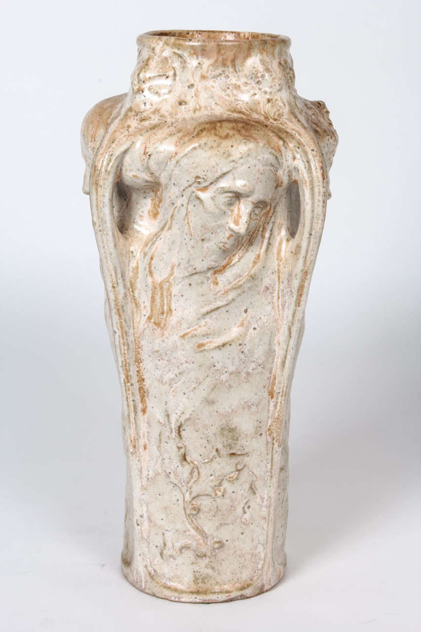 FIRMIN-MARCELIN MICHELET  Sculptor (1875-1951) France 
GENTIL ET BOURDET  [pottery]

“Four Seasons” vase  c. 1900

Glazed stoneware in a cream color with tan and light brown highlights molded with four female profiles and corresponding floral