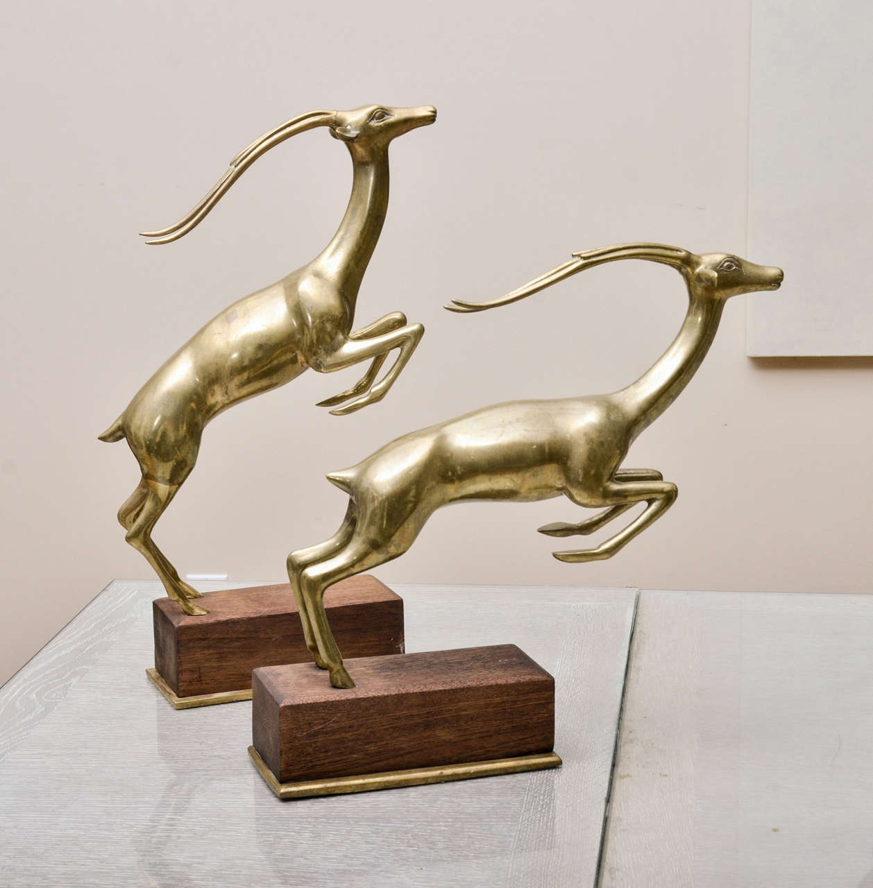 Pair of brass gazelles on wood stands with brass bases. Very well made & substantial.American, ca. 1970's.