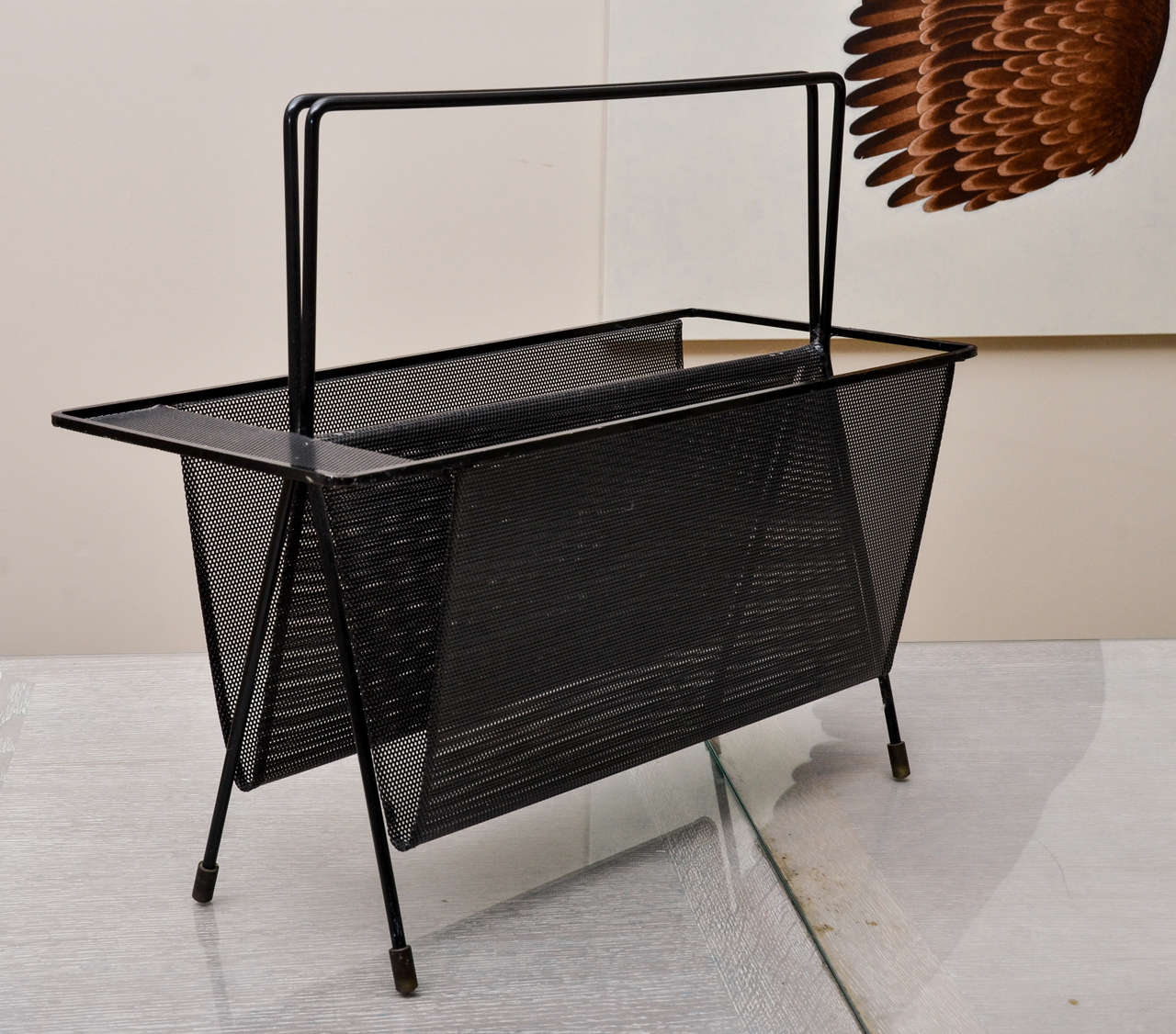 The nicest Mategot magazine rack we have ever seen. Classic Mategot perforated metal in black, with bronze sabots.