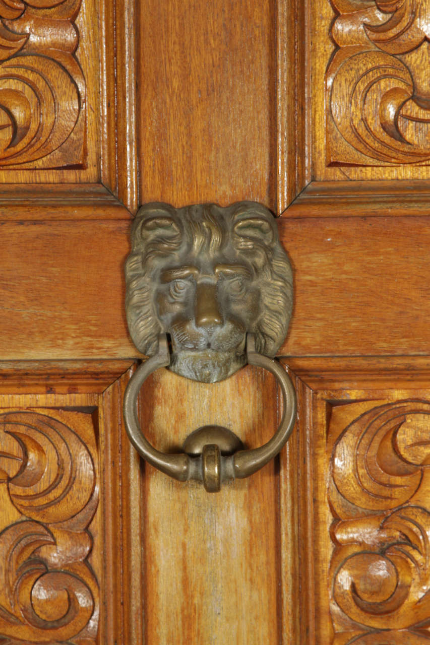 Carved Wooden Spanish Style Entry Door with Bronze Doorknocker at