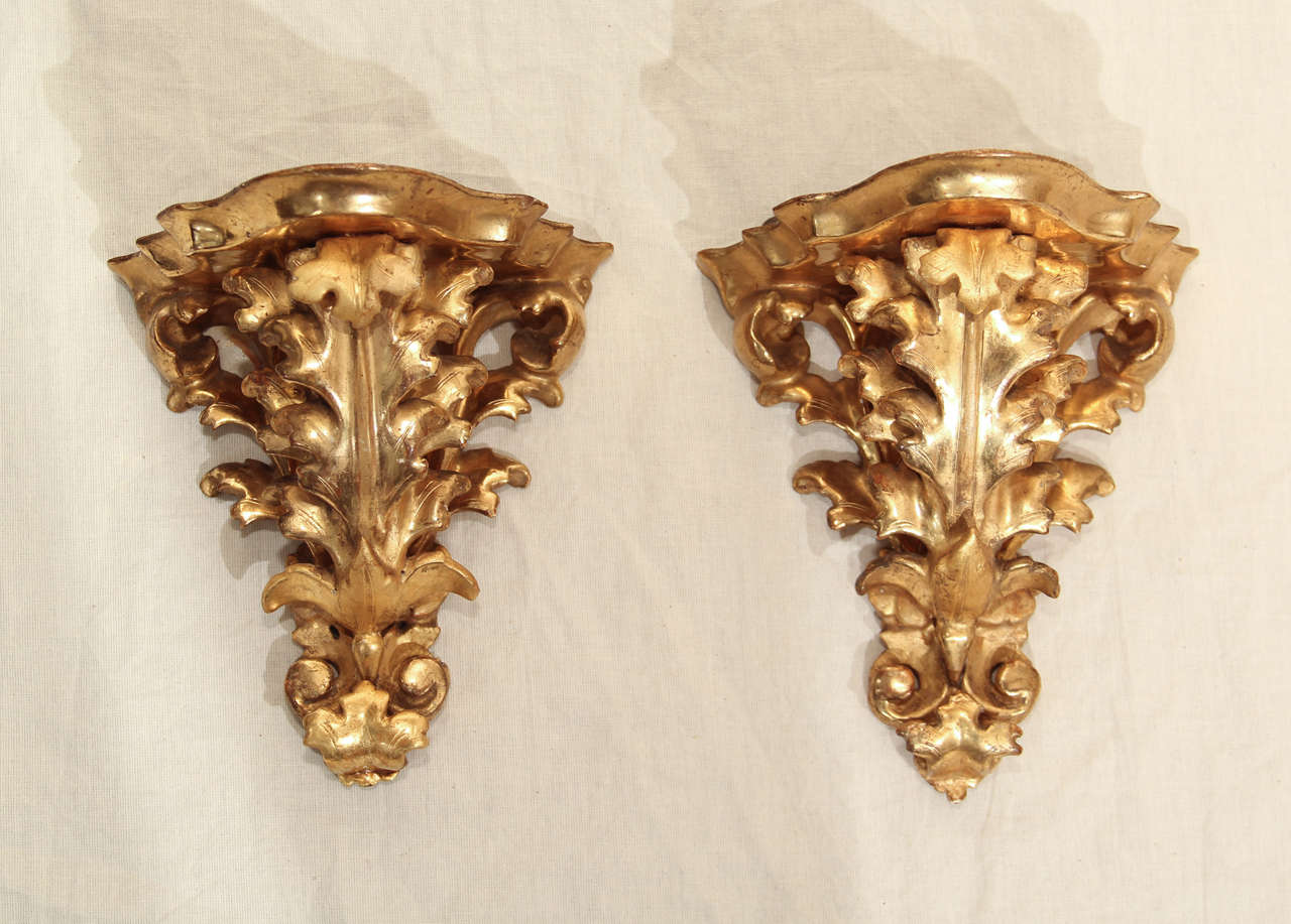A pair of 19th century Italian water gilt wall brackets with acanthus leaf motif