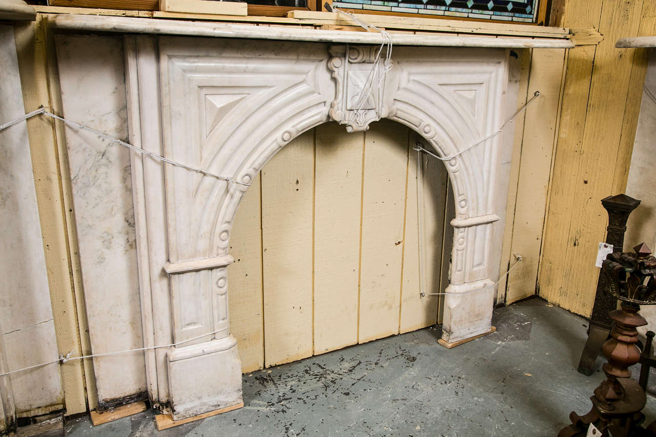 Nice  carrara marble mantel salvaged from an upper East Side residence in New York City.  This arched opened mantels has a great look.  Beautiful original keystone in center.  Opening is 34.5: