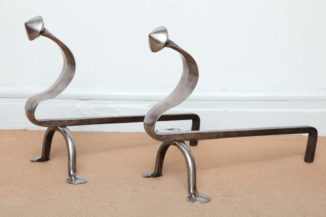 Unusual pair of polished steel Arts and Crafts andirons, the pointed finials over 