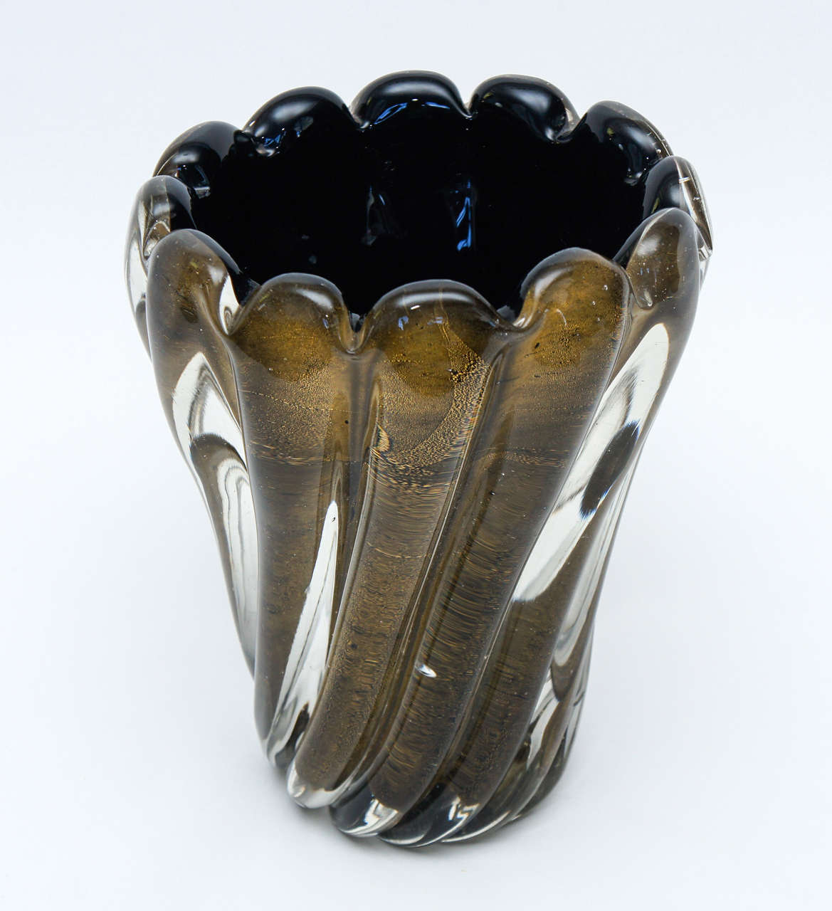 Stunning Italian vase in the Sommerso style. Heavy cased glass with gold dust inclusions creates a dramatic and substantive result. The vase is in excellent condition with bubble inclusions that occurred during production. The pontil is polished and