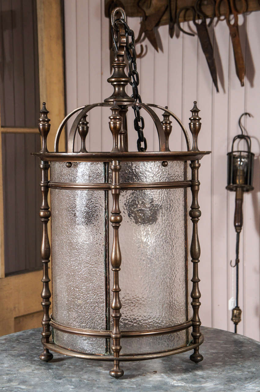 heavy brass cylindrical hall or entrance fixture - retains original leaded curved glass panels - three sockets - rewired with 6' chain and canopy - old patina