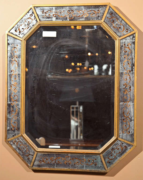  French mirror or looking glass, circa 1940s, bronze framed with églomisé glass border.  By Maison Jansen. 

