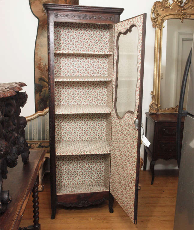 Early 19th c. French Walnut faced bonnetiere. Walnut facing with oak sides. Beveled glass panel in door.