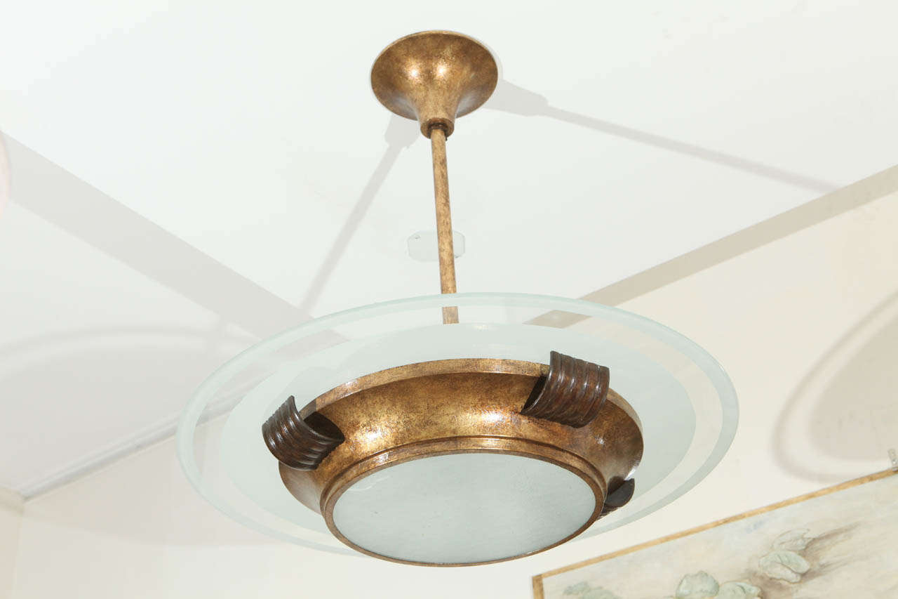 Art Deco Chandelier in antique brass and antiqued gold leaf. Original round frosted glass.