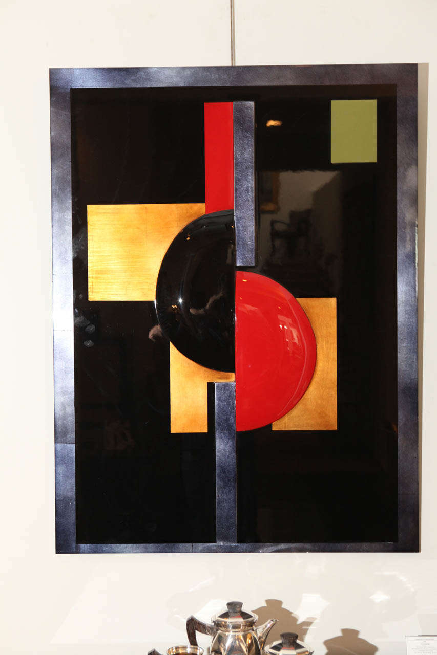 This bold panel by German artist Eliade Ispas features red and black lacquer as well as gold and silver leaf accents. It is heavily influenced by cubist and constructivist design traditions and employs a number of foundational shapes in its