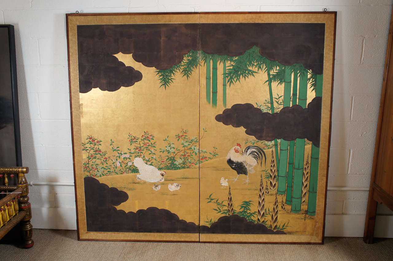 Here is a beautiful Japanese wall screen depicting a scene of chickens and a rooster with a bamboo garden motif with excellent painting detail. This is one of two screens that are a matching set.