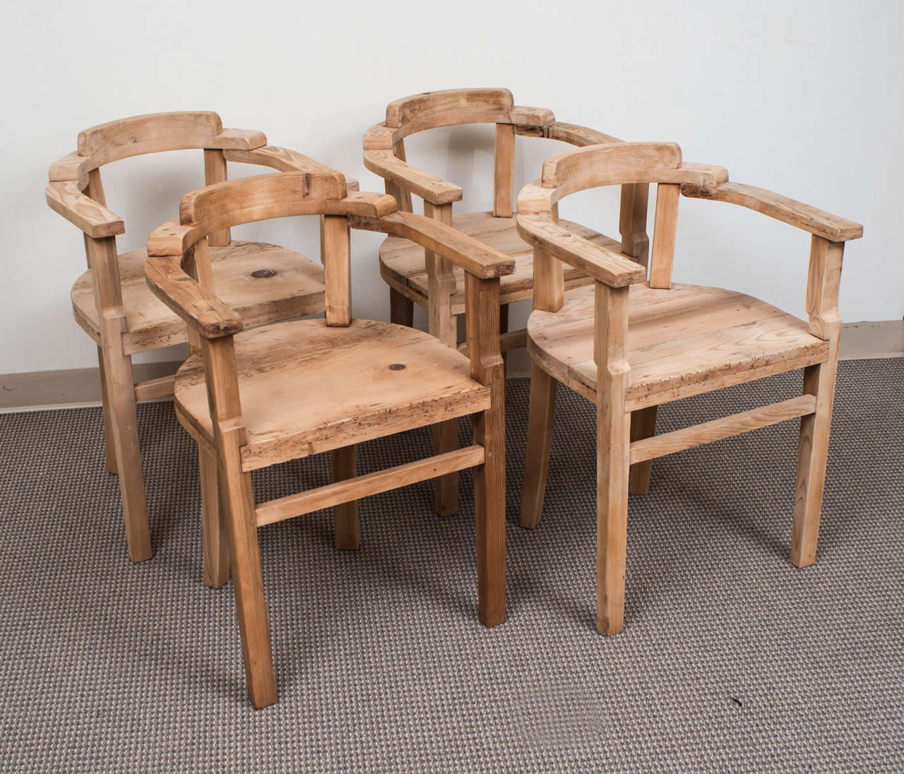 An unusual set of four small pine armchairs in a rustic 