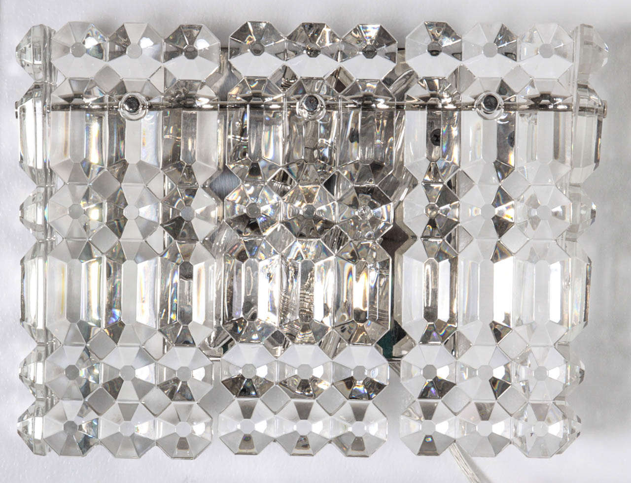 Fantastic box form sconces composed of geometric, rectangular shaped crystal prisms, by Kinkeldey. 2 sockets in each sconce. Rewired for use in the USA. Currently matching chandelier is also available.