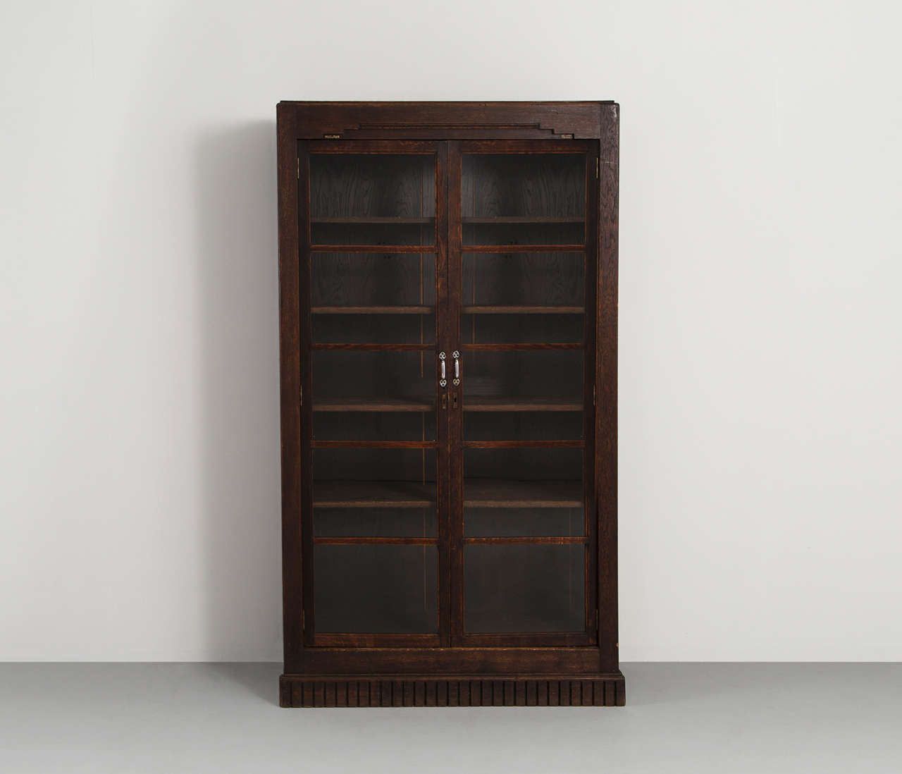 A pair of large showcases / pharmacist closet, with glass door panels.
The piece are made out of stained oak. 

The cabinets provide plenty of storage space due to its four adjustable shelves.
Please note the elegant details in the woodwork,