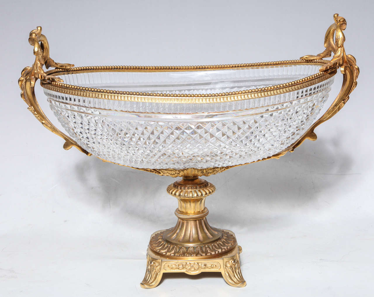 Antique hand diamond cut crystal and gilt bronze mounted centerpiece, attributed to Baccarat. The finely cast and hand chased gilt bronze is modeled into curving floral leaves.