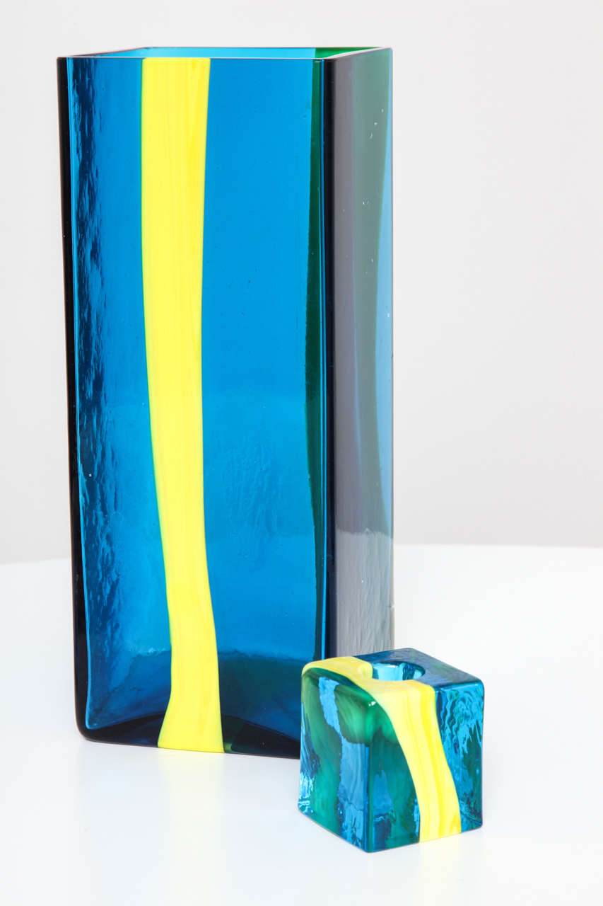 Stunning art glass pairing executed in deep Mediterranean blue with electric yellow stripe. Engraved signature [venini Pierre Cardin] to both pieces.

Candleholder measures 2.25 x 2.25 x 2.5"H.
