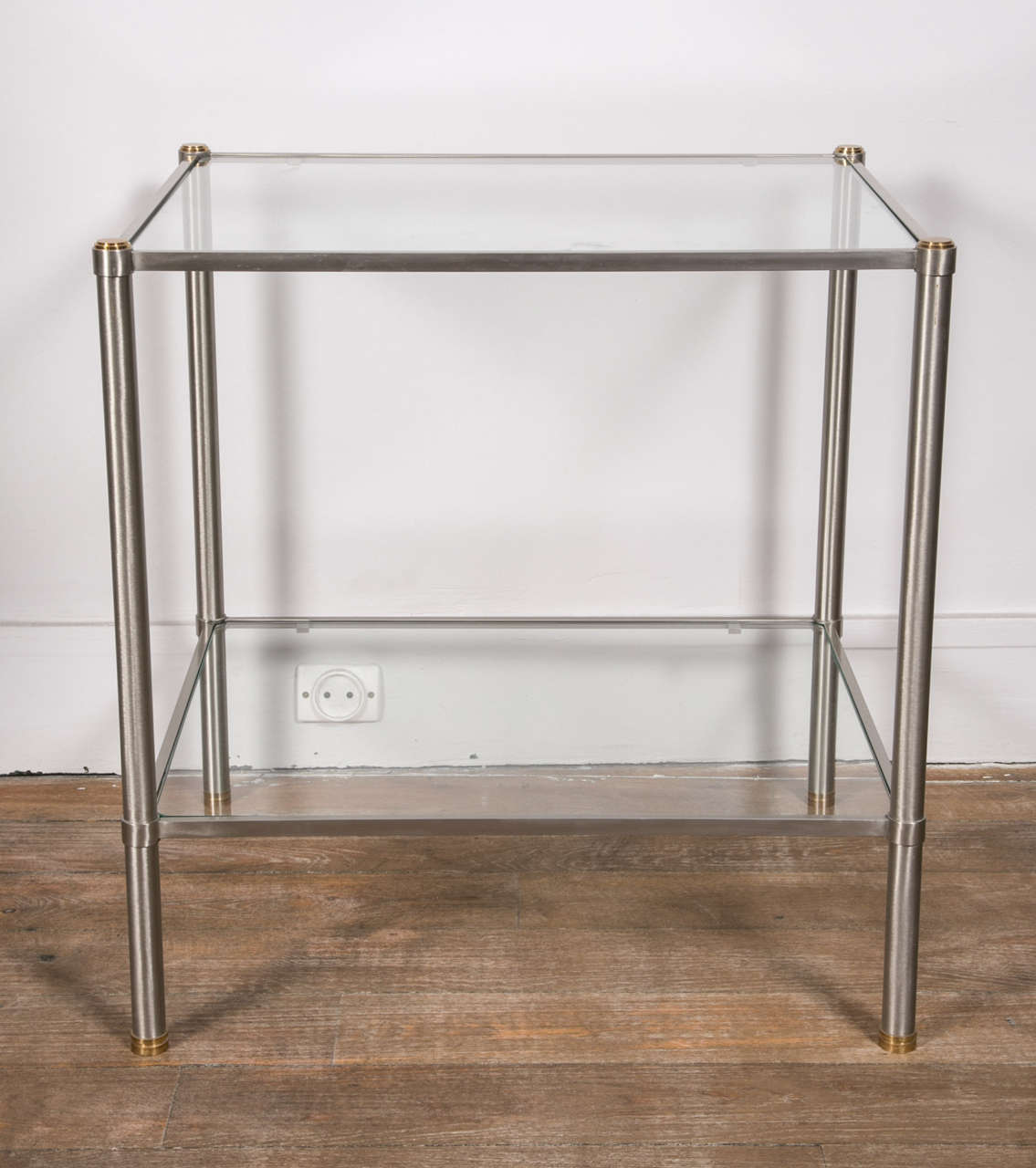 A pair of two-tiers brushed steel end tables
Glass shelves .
France, 1960