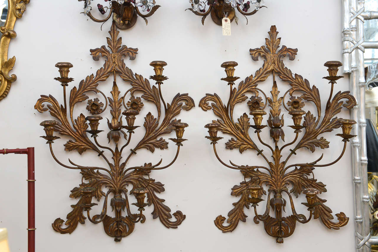 Beautiful eight-arm gilt metal wall sconces with original patina and wood candleholders.