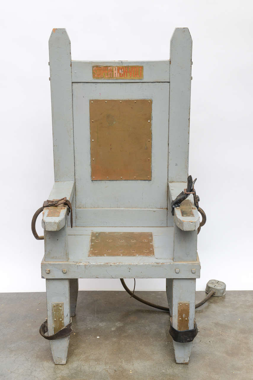 An extraordinary find! This primitive 1930s electric chair came from an Appalachian prison. There are conductive copper plates on the arms, legs, seat and back, as well as leather holding straps.