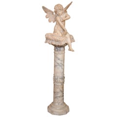 Alabaster Figure Winged Angel Sitting On A Pillow on an Alabaster Pedestal