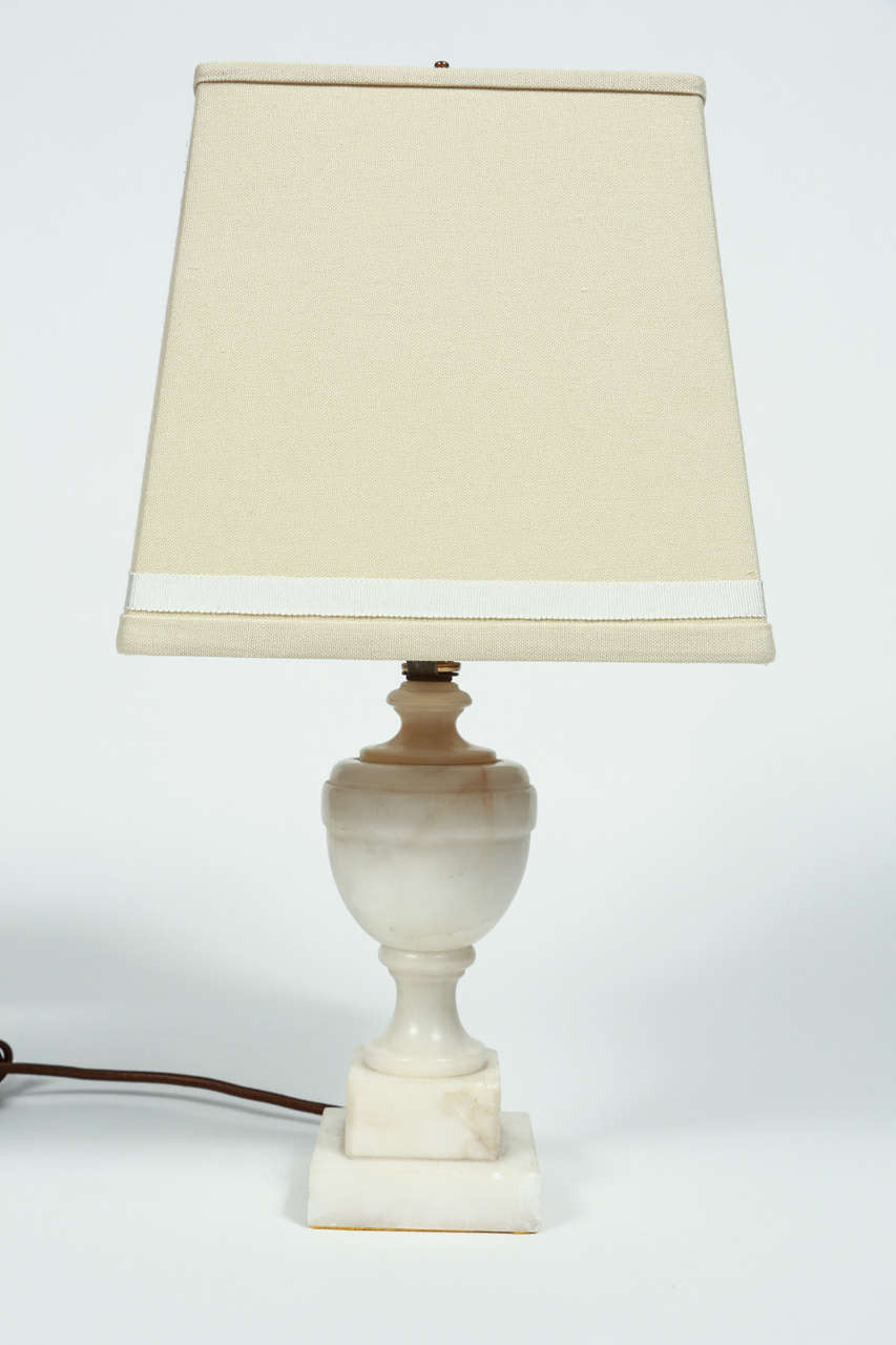 Petite alabaster lamp. Custom made shade with grosgrain trim. 

DIMENSIONS: 18 3/4